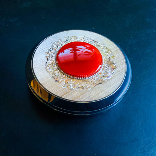Elegance Deluxe vintage compact with a bold red dome and tortoiseshell-style resin accents, Showa era (1960s–1970s).