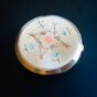 Vintage Pink Lady compact with engraved floral motif and hand-painted pastel accents, Showa era (1960s–1970s).