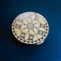 Vintage Pola “Micro Puff” compact (1960) with intricate engraved floral and geometric design.