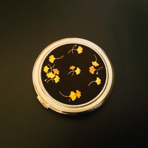 Showa-era Higo zogan compact with gold inlaid ginkgo leaves on black iron lid