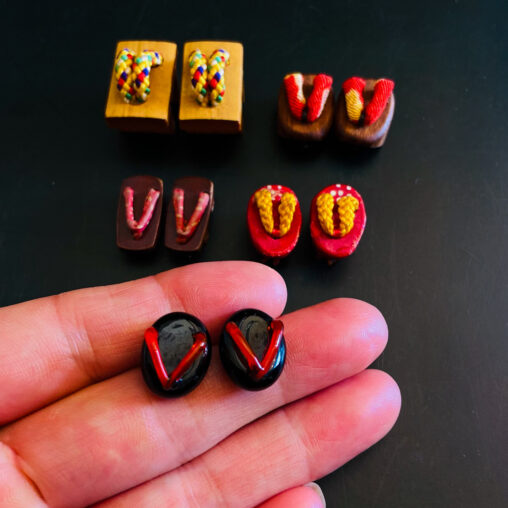 Set of miniature Japanese geta sandals with red and multicolored straps, Showa era