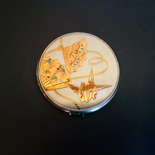 Showa-era Japanese compact with golden kite and origami motifs, enamel decoration